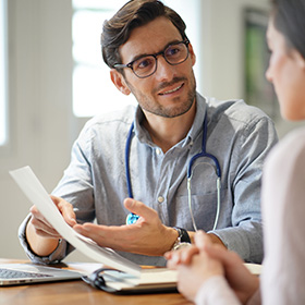 male doctor consulting with patient discussing health reports in office setting with medical documents and stethoscope 13 health tips for patients