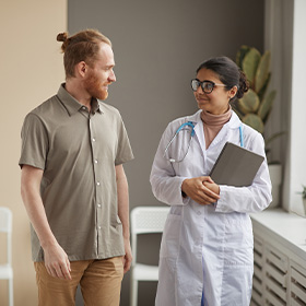 man and woman discussing in medical office featuring doctor and patient 7 important health tips for better living