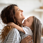mother and daughter joyfully embracing with smiles and laughter capturing a special moment of love and happiness celebrating 16 years of bond