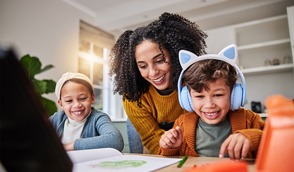 happy mother helping children with creative activities at home engaging with three colorful art supplies